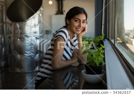Portrait of beautiful woman by window at office 34362837