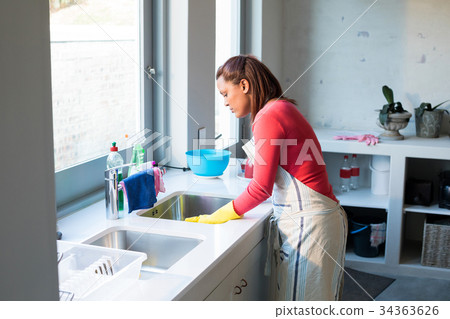 Woman washing utensil in kitchen sink Woman washing utensil in kitchen sink 34363626