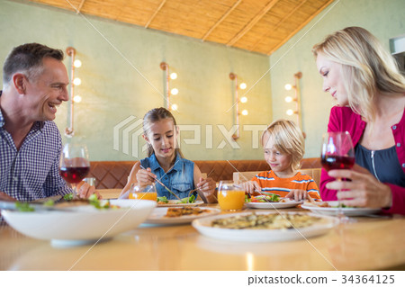 Family having dinner at restaurant 34364125