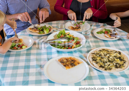 Family eating food at restaurant 34364203