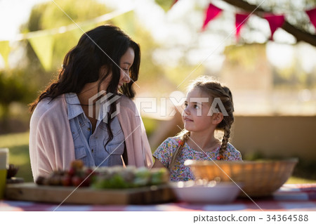 Mother and daughter enjoying together in the park 34364588