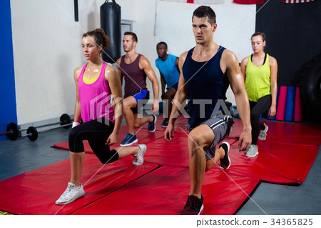 Young athletes practicing lunge exercise 34365825