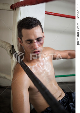Wounded boxer relaxing in the boxing ring 34365928