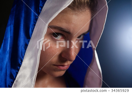 Determined woman wearing boxing robe 34365929