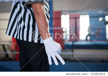 Midsection of male referee gesturing with hand Midsection of male referee gesturing with hand 34365931