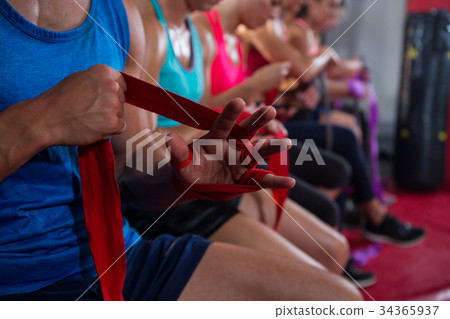 Close-up of athletes wrapping bandages Close-up of athletes wrapping bandages 34365937