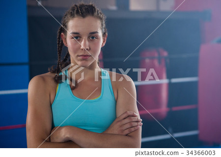 Portrait of confident young female athlete with arms crossed Portrait of confident young female athlete with arms crossed 34366003
