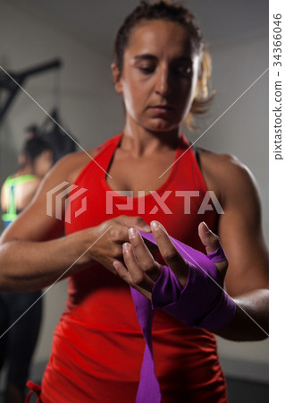 Woman tying hand wrap on hand Woman tying hand wrap on hand 34366046