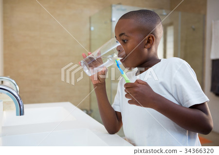 Boy drinking water from glass Boy drinking water from glass 34366320