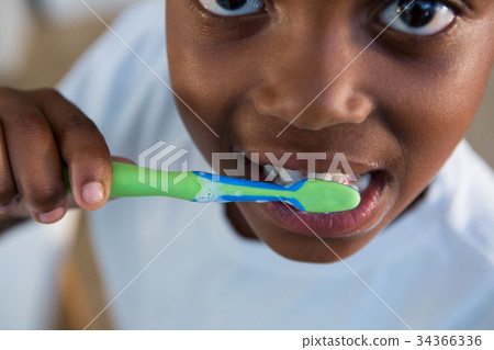 Mid section of boy brushing teeth Mid section of boy brushing teeth 34366336