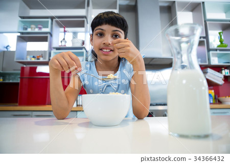 Portrait of girl eating healthy breakfast 34366432