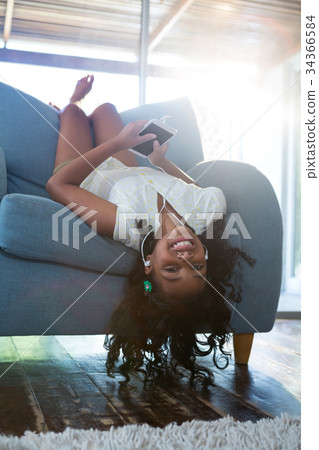 Upside down portrait of girl relaxing on armchair 34366584