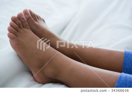 Low section of girl on bed 34366636