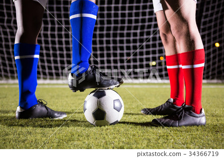 Low section of soccer players with ball on field 34366719