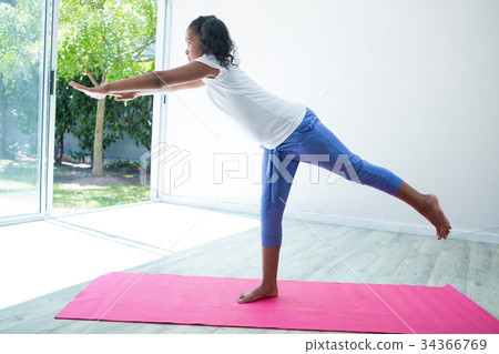 Girl exercising against wall Girl exercising against wall 34366769