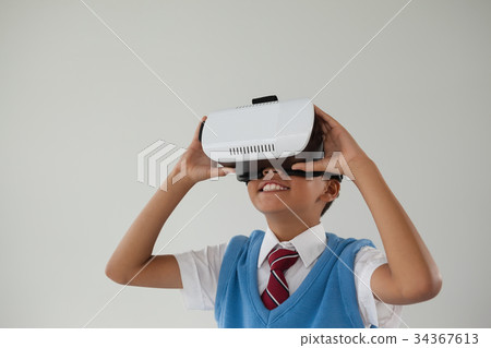 Schoolboy using virtual reality headset 34367613