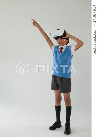 Schoolboy using virtual reality headset 34367614