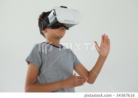 Schoolboy using virtual reality headset 34367616