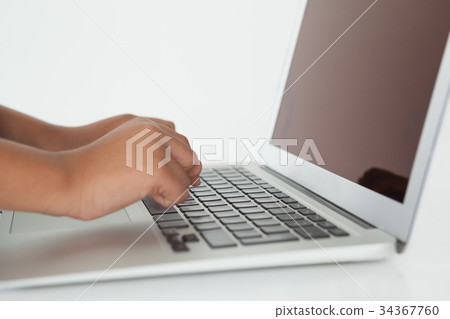Schoolboy using laptop Schoolboy using laptop 34367760