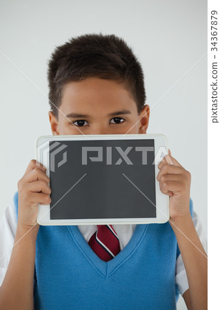 Schoolboy holding digital tablet against white background 34367879