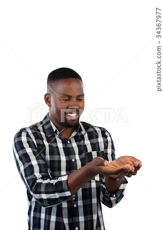 Man standing with hands cupped against white background 34367977