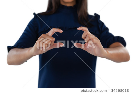 Female executive forming a finger frame 34368018
