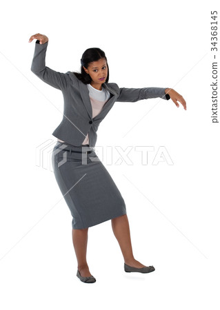 Businesswoman dancing against white background Businesswoman dancing against white background 34368145