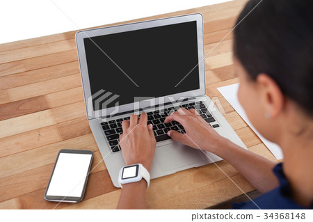 Businesswoman using laptop on the table Businesswoman using laptop on the table 34368148