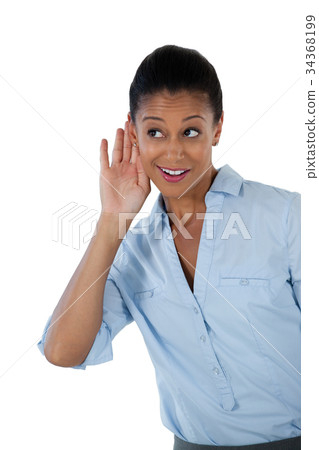 Businesswoman listening secretly with hands behind her ears Businesswoman listening secretly with hands behind her ears 34368199