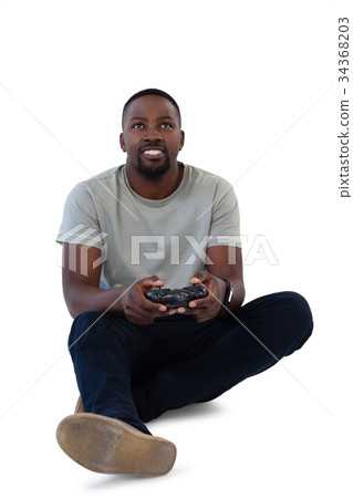 Man playing video game against white background 34368203