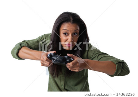 Woman making funny faces while playing video games 34368256
