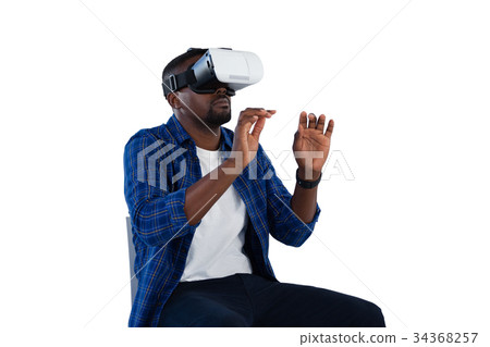 Man gesturing while using virtual reality headset 34368257