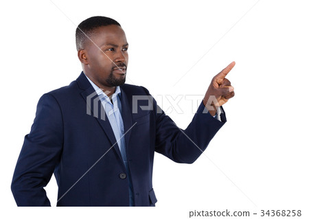 Businessman pressing an invisible virtual screen Businessman pressing an invisible virtual screen 34368258