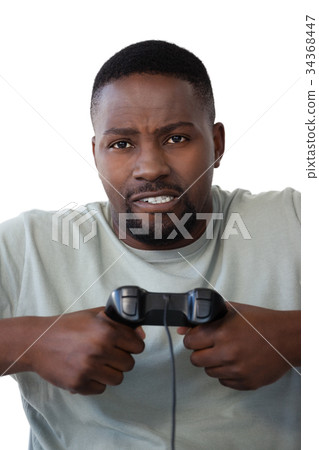 Frustrated man holding joystick against white background Frustrated man holding joystick against white background 34368447