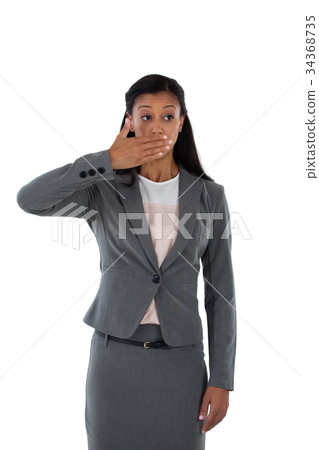Surprised businesswoman covering her mouth with hand Surprised businesswoman covering her mouth with hand 34368735