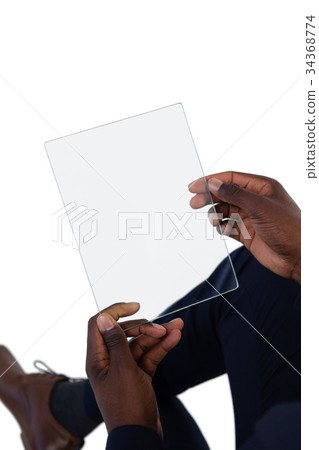 Businessman using a glass digital tablet 34368774