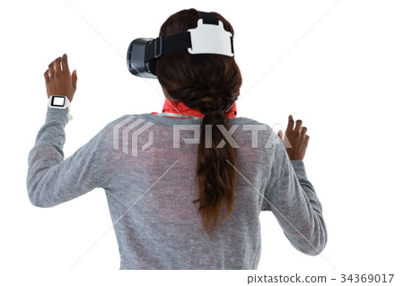 Rear view of young woman gesturing while using vr glasses 34369017