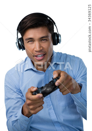 Portrait of smiling young businessman playing video game Portrait of smiling young businessman playing video game 34369125