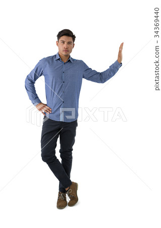 Portrait of young businessman standing with hand on hip 34369440