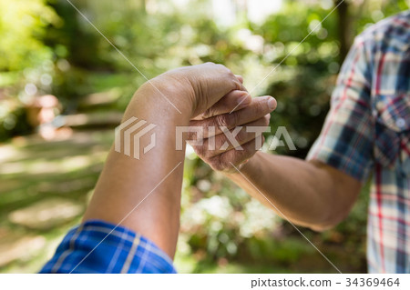 Senior couple holding hands Senior couple holding hands 34369464
