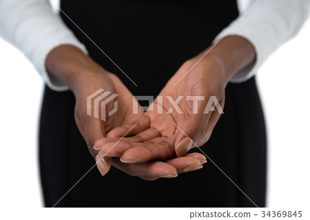 Mid section of businesswoman holding something with hands cupped 34369845