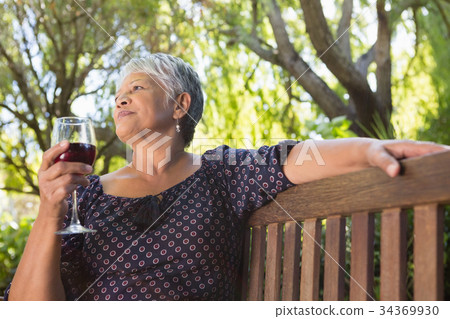 Senior woman holding wine glass Senior woman holding wine glass 34369930