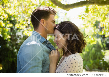 Man kissing woman on forehead Man kissing woman on forehead 34369932
