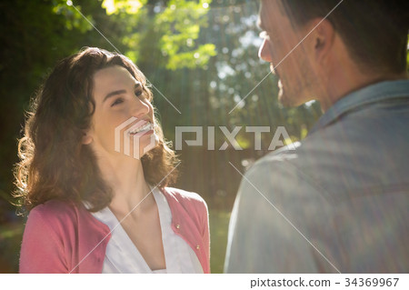 Romantic couple looking face to face in garden 34369967