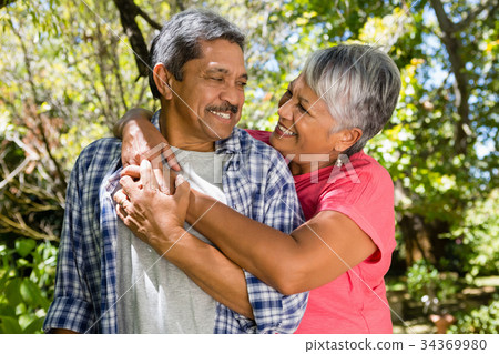Romantic senior couple looking face to face in garden 34369980