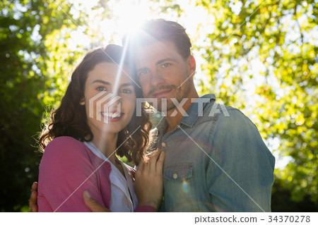 Romantic couple holding hands in garden Romantic couple holding hands in garden 34370278