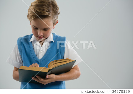 Schoolboy reading book 34370339