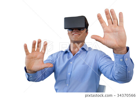 Smiling businessman sitting chair while wearing vr glasses Smiling businessman sitting chair while wearing vr glasses 34370566
