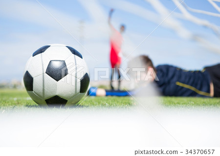 Goalkeeper lying on field while playing soccer Goalkeeper lying on field while playing soccer 34370657