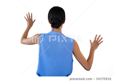 Businesswoman in sleeveless clothing touching interface 34370916